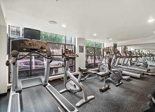 A gym with treadmills, exercise bikes, and other equipment.