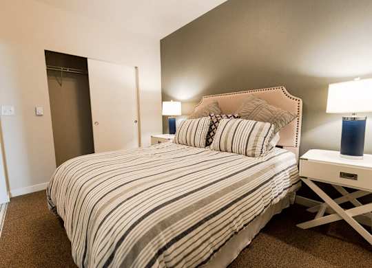A bedroom with a bed, nightstand, and lamp. at The Platform, Washington, 98032