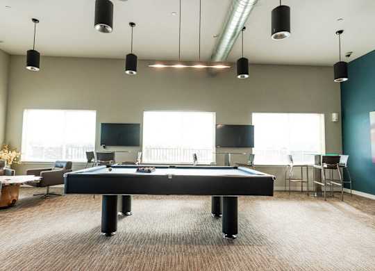 A room with a pool table and a television. at The Platform, Washington