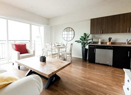 A modern living room with a wooden floor and white walls. at The Platform, Kent, WA, 98032