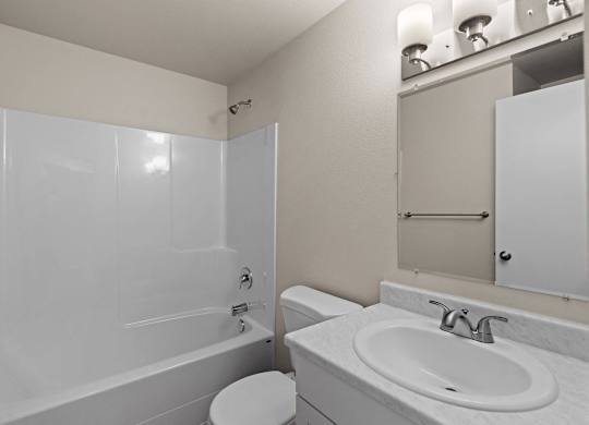 a bathroom with a sink and a toilet and a shower at Bellamy Park Apartments , Lakewood, Washington