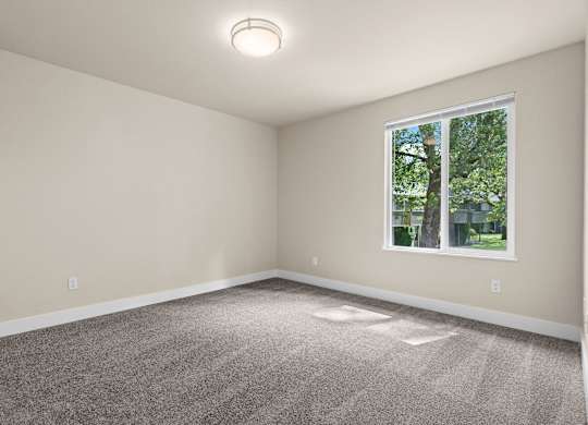an empty room with carpet and a window at Bellamy Park Apartments , Lakewood, CA, 98498