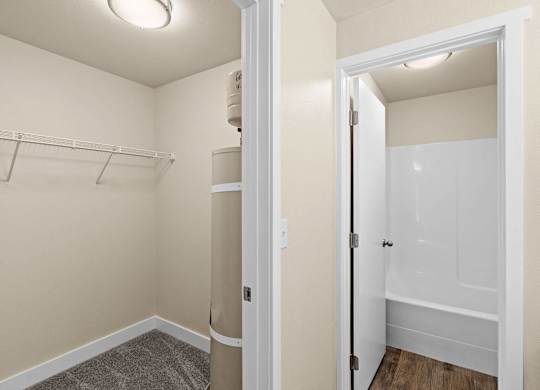 a renovated bathroom with a closet and a shower and a toilet at Bellamy Park Apartments , Lakewood, 98498