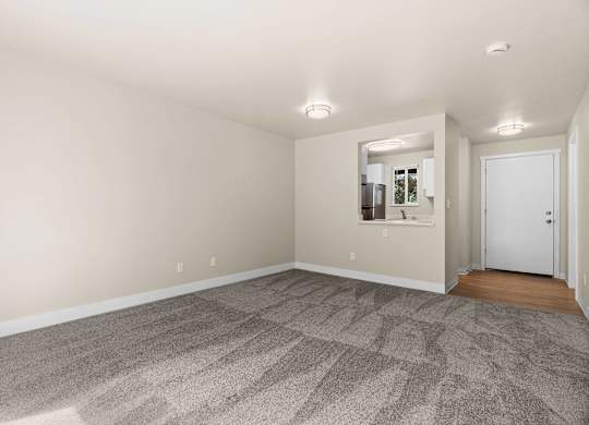 a living room with carpet and a door to a bathroom at Bellamy Park Apartments , Lakewood, 98498