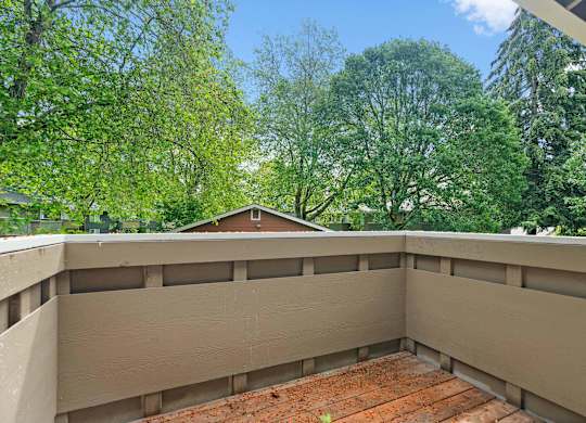 the view from the top of a balcony overlooking the trees at Bellamy Park Apartments , Lakewood, CA