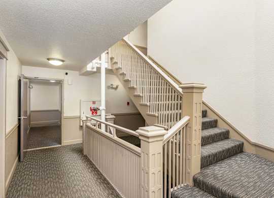A staircase with a red sign on the wall.