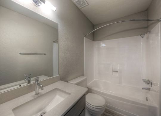 A white sink and toilet in a small bathroom.