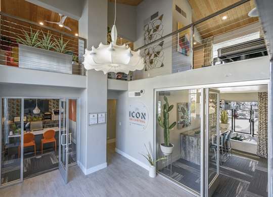 A modern office space with glass walls and a white ceiling light.