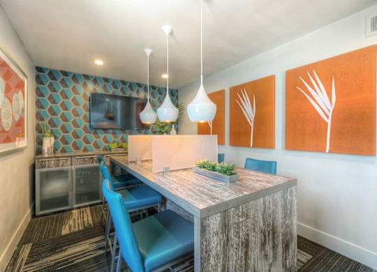 A dining area with a wooden table and blue chairs.