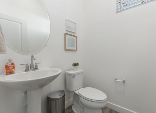 A white toilet sits next to a sink in a bathroom.