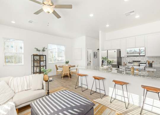 A modern living room with a bar area and a kitchen in the background.