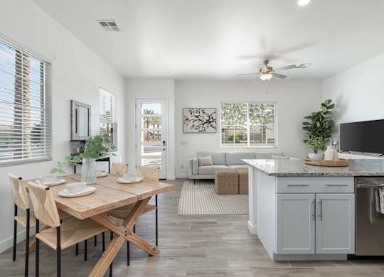 A kitchen with a table and chairs in the middle of the room.