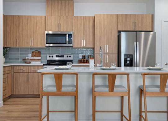 A kitchen with wooden cabinets and a white countertop.