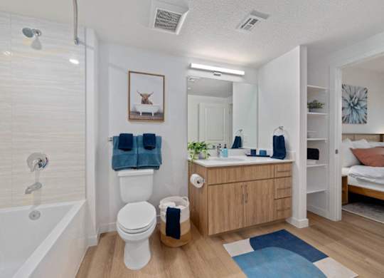 A bathroom with a white toilet, a white sink, and a white bathtub.