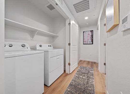 A laundry room with a washer and dryer.