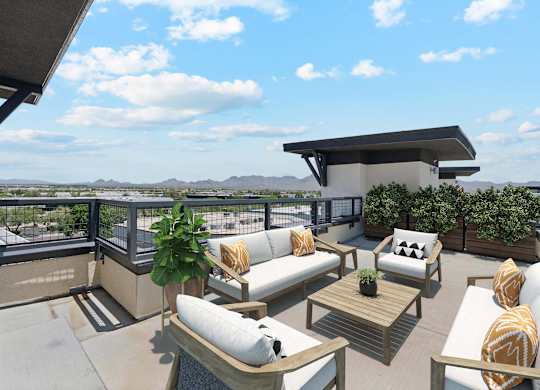 A patio with a couch, chairs, and a table with a view of the mountains.