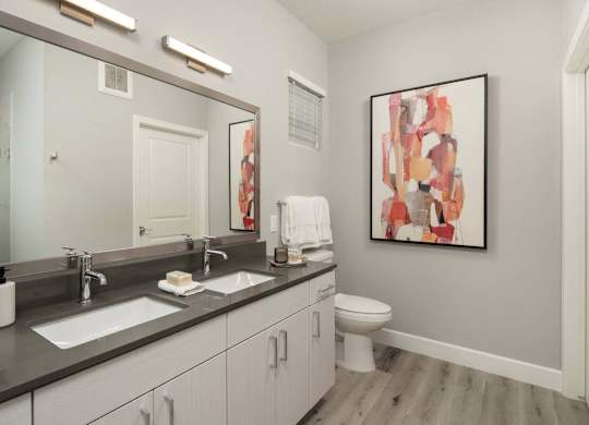 A bathroom with a large mirror, a sink, a toilet, and a painting on the wall.