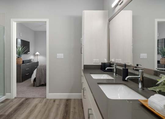 A modern bathroom with a walk-in shower and double sink vanity.