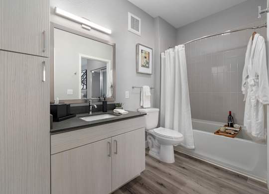 A modern bathroom with a white toilet and a white shower curtain.