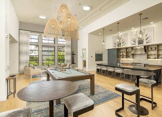 A modern dining room with a large table and chairs.