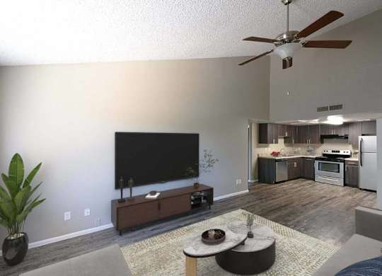 A living room with a television, a plant, and a couch.