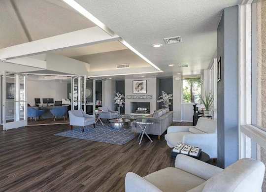 A living room with a fireplace and a dining table.