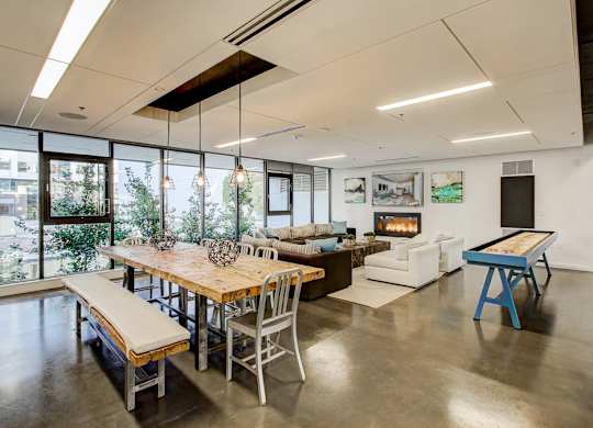 A modern dining room with a wooden table and chairs.