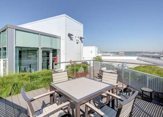A modern building with a patio and a table.