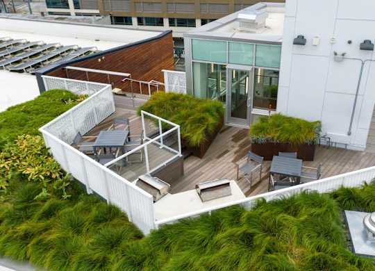 A rooftop patio with a table and chairs.