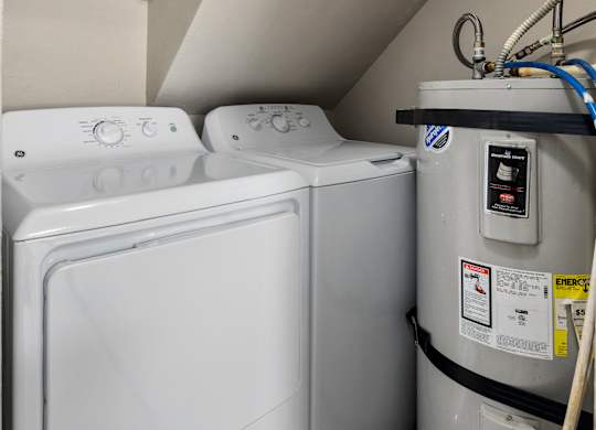 A washing machine and dryer in a small laundry room.