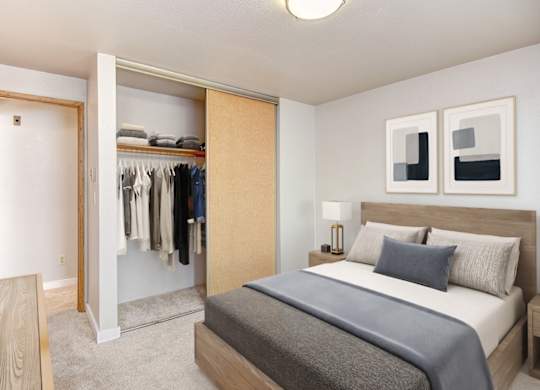 A bedroom with a large bed and a wardrobe.