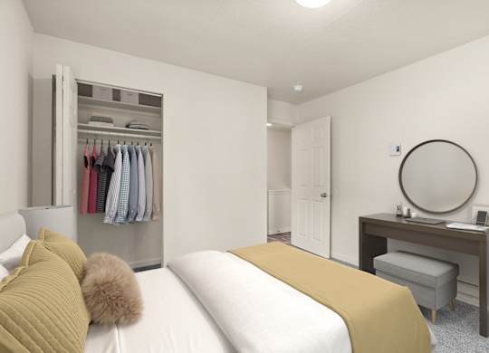 A bedroom with a bed, desk, and wardrobe.
