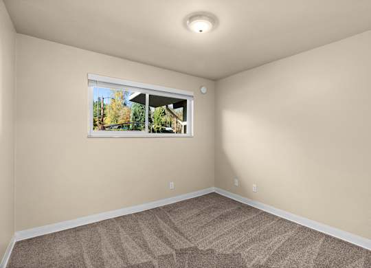an empty room with carpet and a window