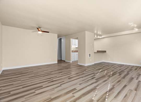 the living room with hardwood floors and a ceiling fan