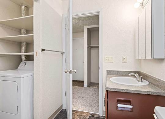A white washer and dryer are in a small laundry room. at Brookstone, SeaTac, WA, 98198