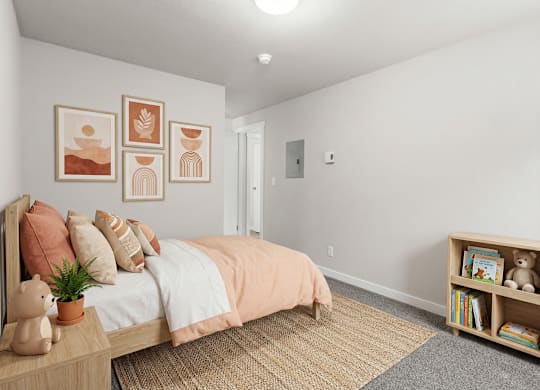 A bedroom with a bed, pillows, a nightstand, a bookshelf, and pictures on the wall.