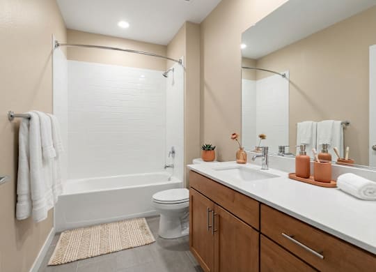 A bathroom with a white toilet, a white sink, and a white bathtub.