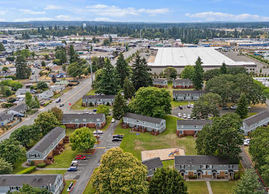 A large aerial view of a town with a mix of residential and commercial buildings.