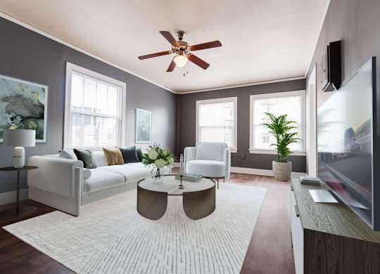 a living room with a white rug and a ceiling fan at Edwards on Fifth, Seattle, Washington