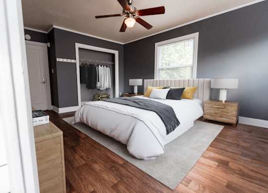 a bedroom with a bed and a ceiling fan at Edwards on Fifth, Seattle, WA