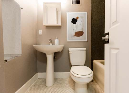 a small bathroom with a toilet and a sink at Edwards on Fifth, Seattle