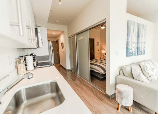 Modern Bedroom Next to Kitchen  at Icon Apartments, Seattle, WA, 98104