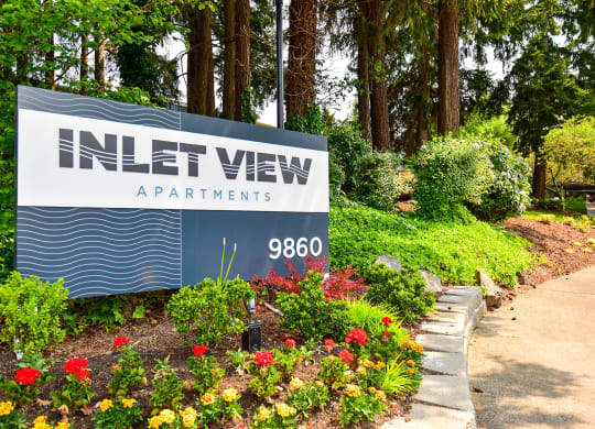 a sign at the entrance to the inlet view apartments