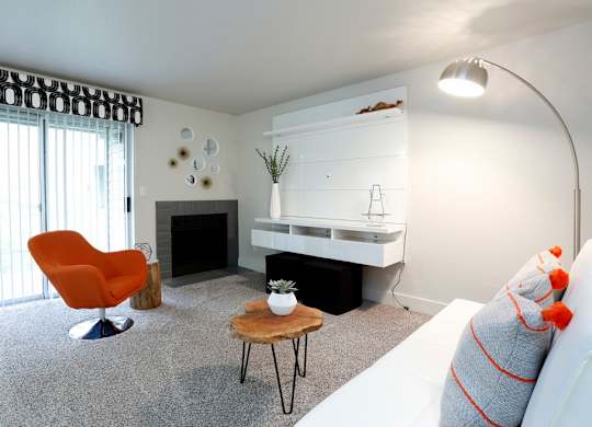 a living room with a couch and a table and a fireplace at Northpoint Apartments, Tacoma, 98407