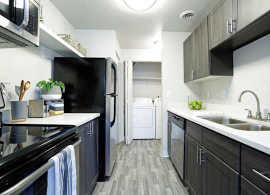 an empty kitchen with a sink and a refrigerator at Northpoint Apartments, Washington, 98407