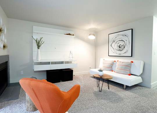 a living room with a white couch and a fireplace at Northpoint Apartments, Tacoma, WA, 98407