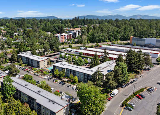 A large building complex with a parking lot in front.