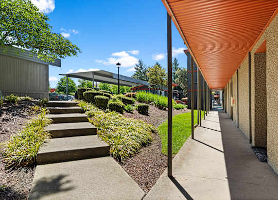 A long corridor with a red roof and a concrete floor.