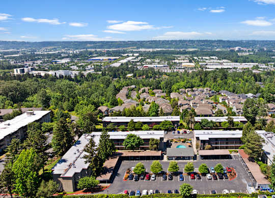 A large building with a parking lot in front of it.