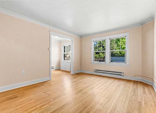 A room with a window and a radiator on the wall.